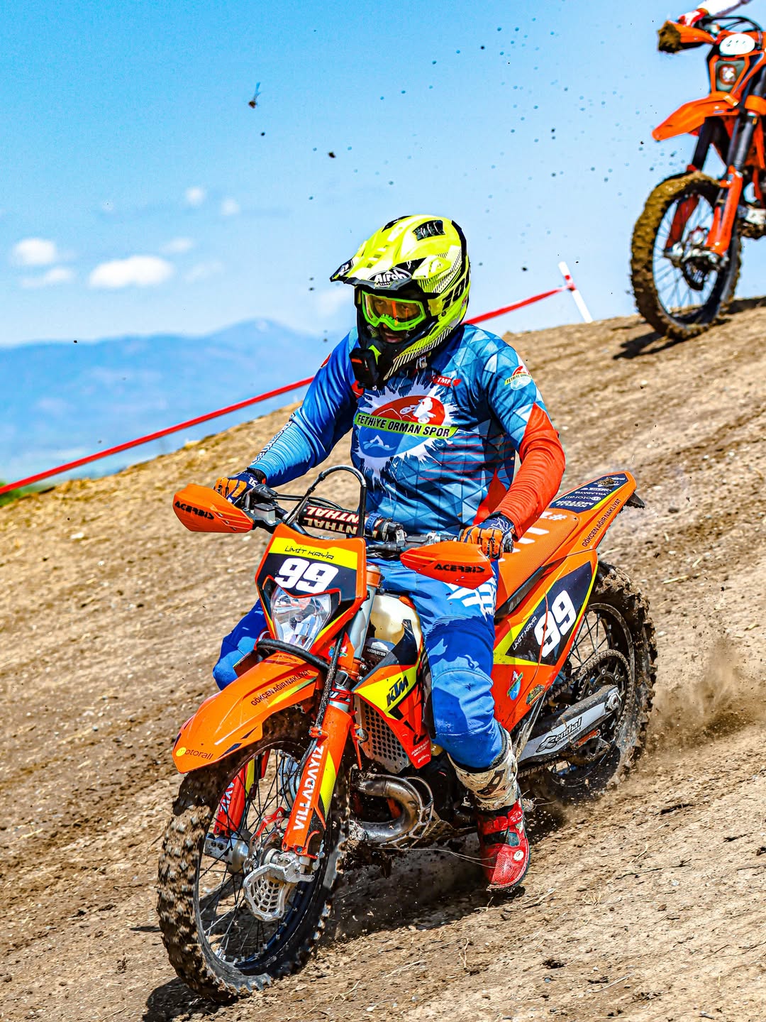 Enduro rider number 99 on a mountain course