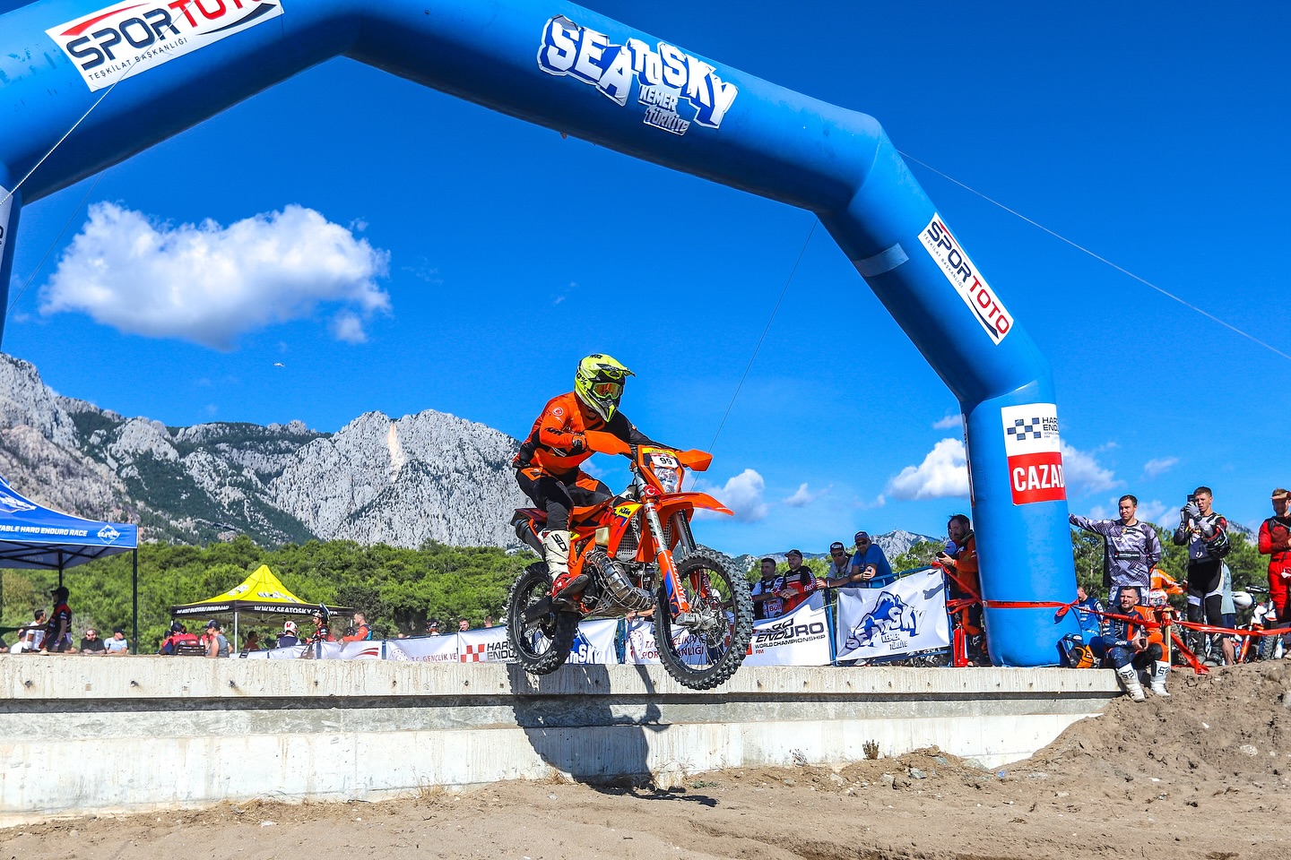 Enduro rider jumping in front of the mountains