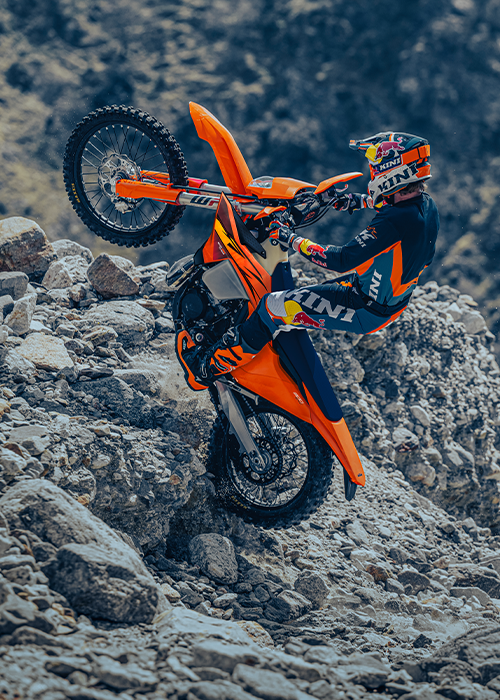 KTM enduro motorcycle climbing a rocky trail